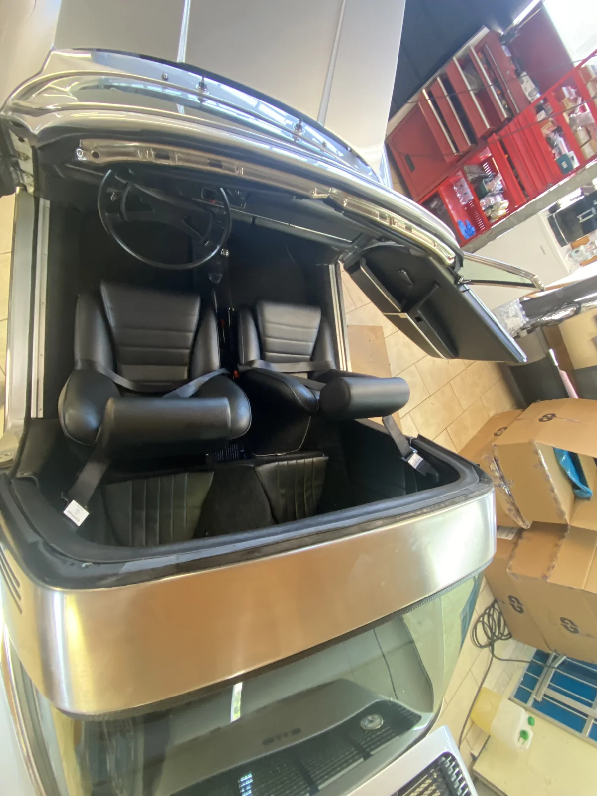 Porsche Targa interior seen from above with the roof open and black leather seats
