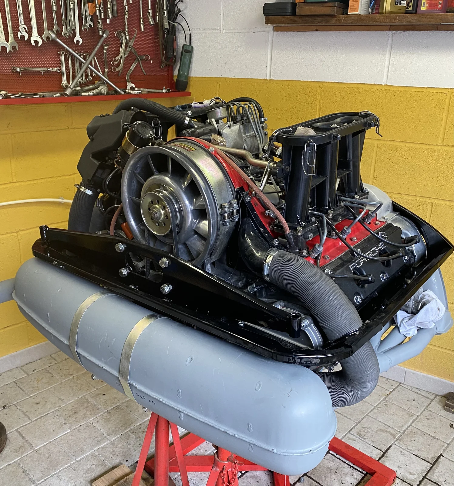 Porsche 911 flat-six boxer engine on a stand during overhaul
