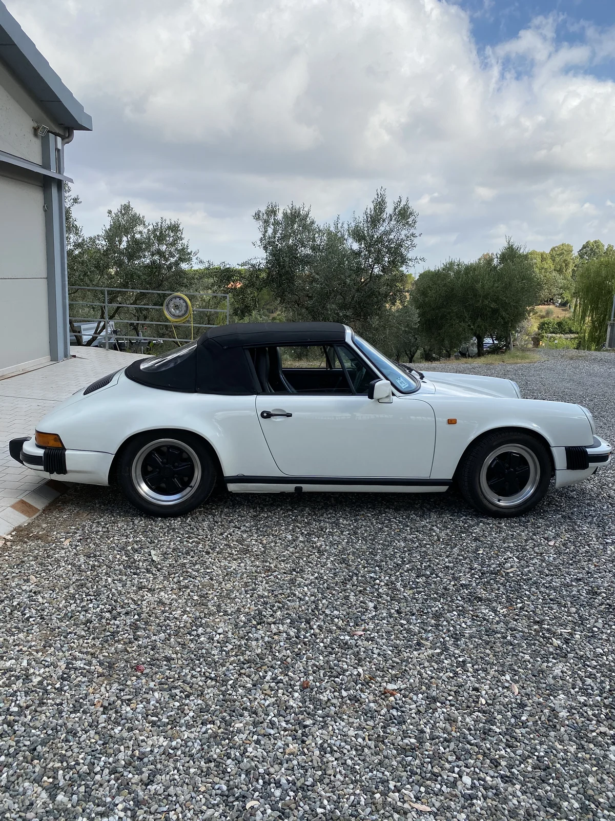 White Porsche 911 SC Cabriolet with soft top up, right profile