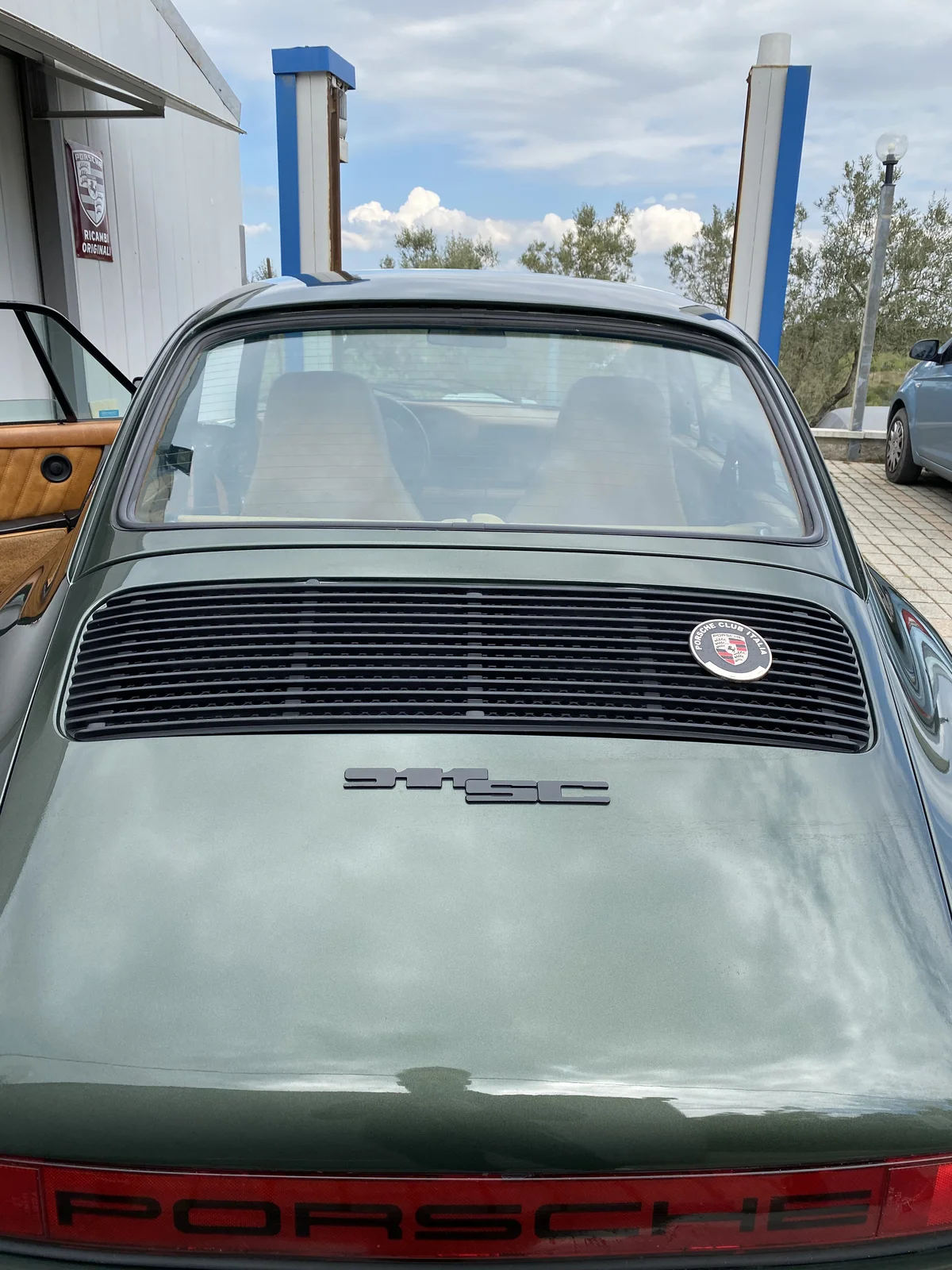 Olive green Porsche 911 SC, rear view with badge and front bonnet
