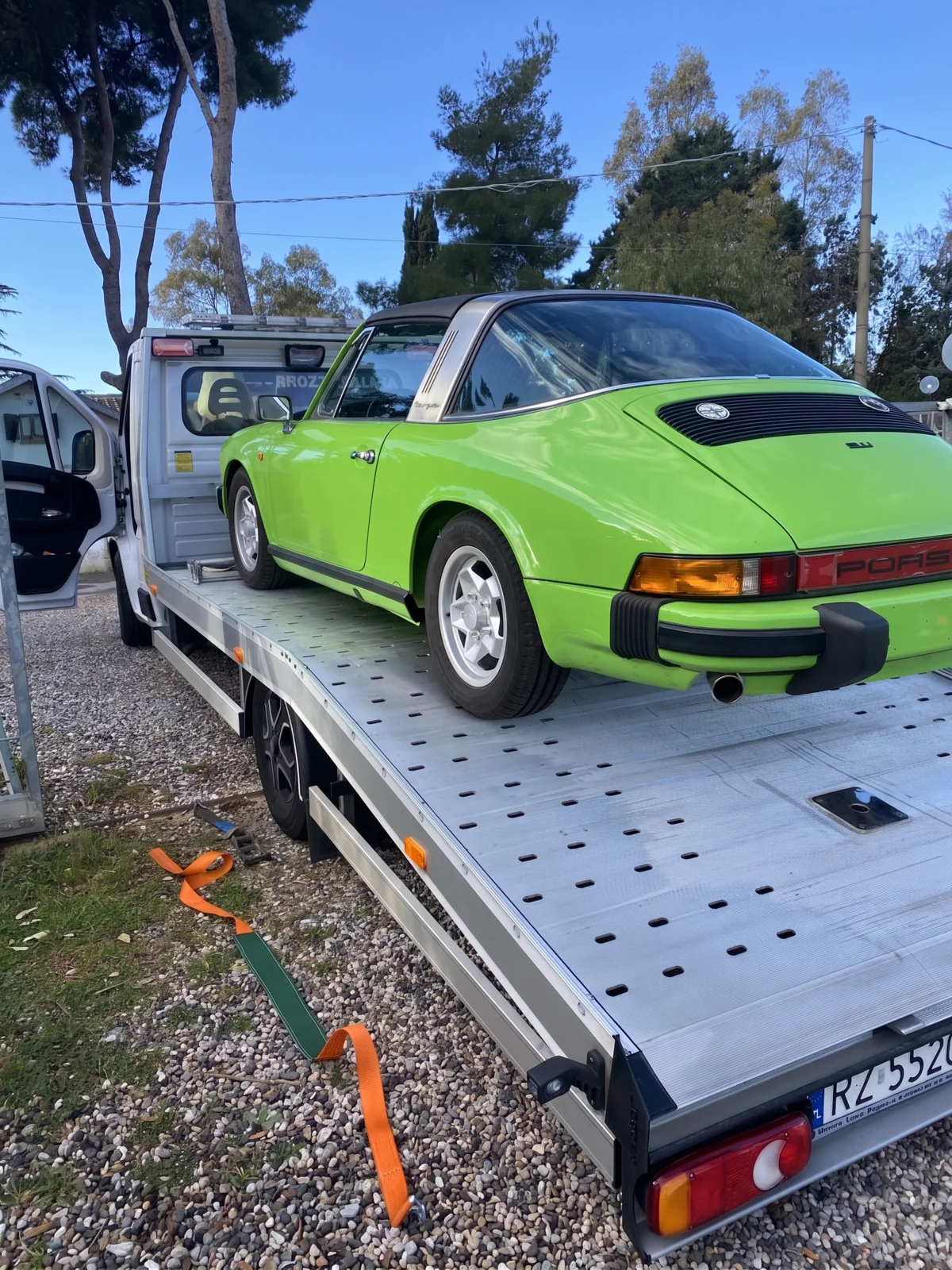 Green Porsche 911 Targa on a car transporter, collected for restoration