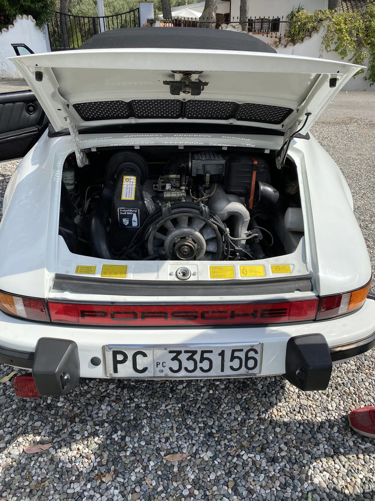 Rear engine bay of white Porsche 911 after complete restoration